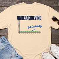 Load image into Gallery viewer, Underachieving but Consistently - Funny Underachiever Shirt in Soft Cream, props flat